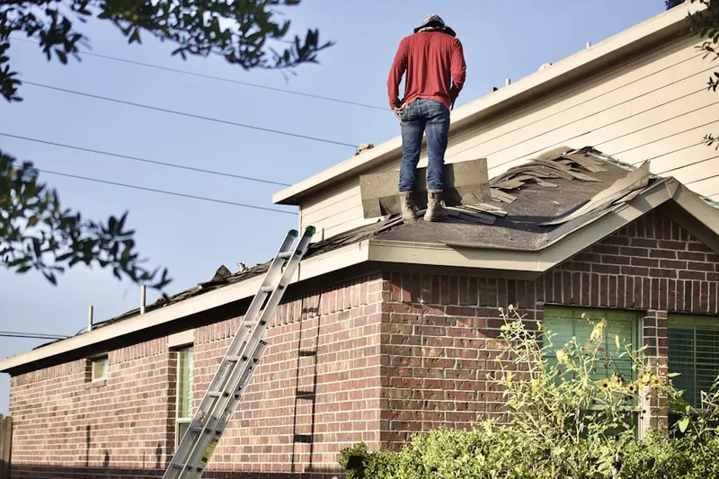 Professional roofer working on a residential roof in The Estates At Wiedemann Mansion